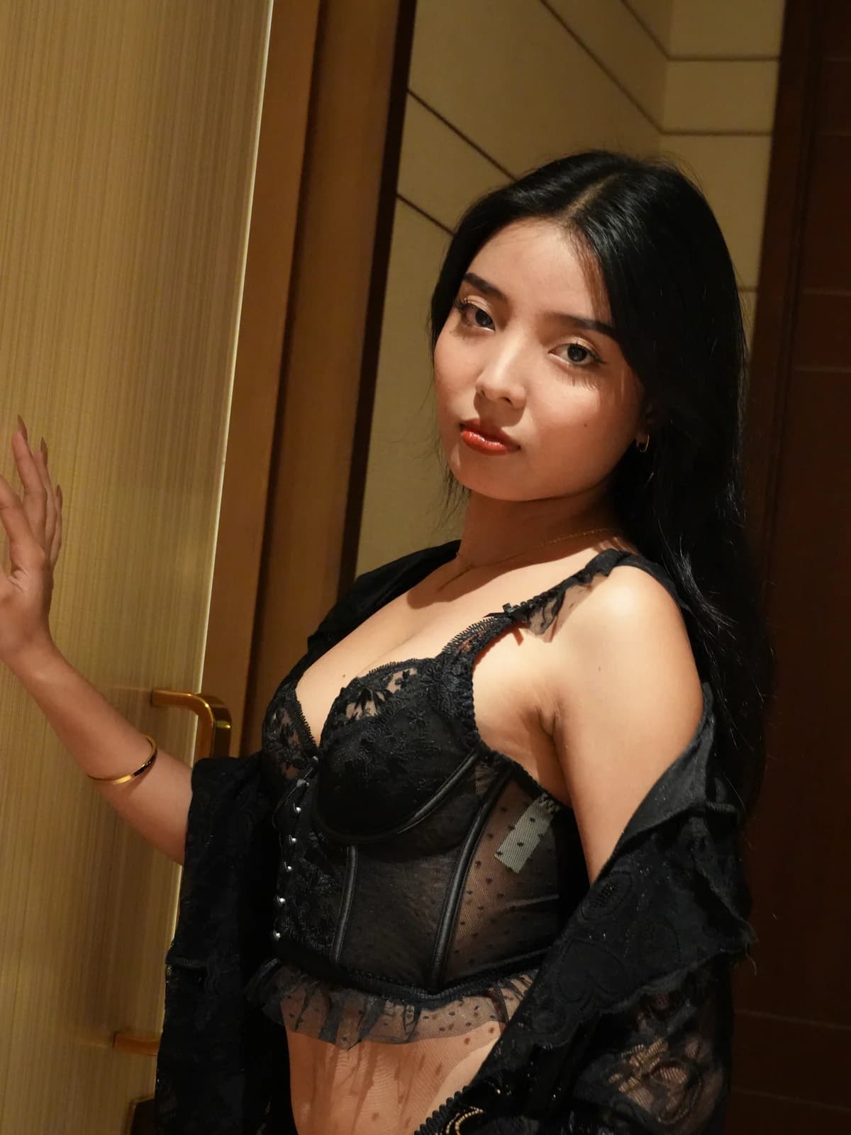 Merchant campaign preview: model in a black structured lace set with a sheer black robe