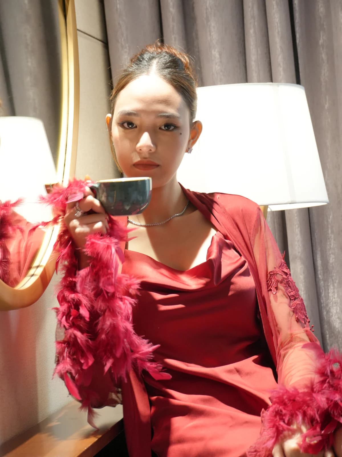 Merchant campaign preview detail: burgundy satin and feathered robe texture