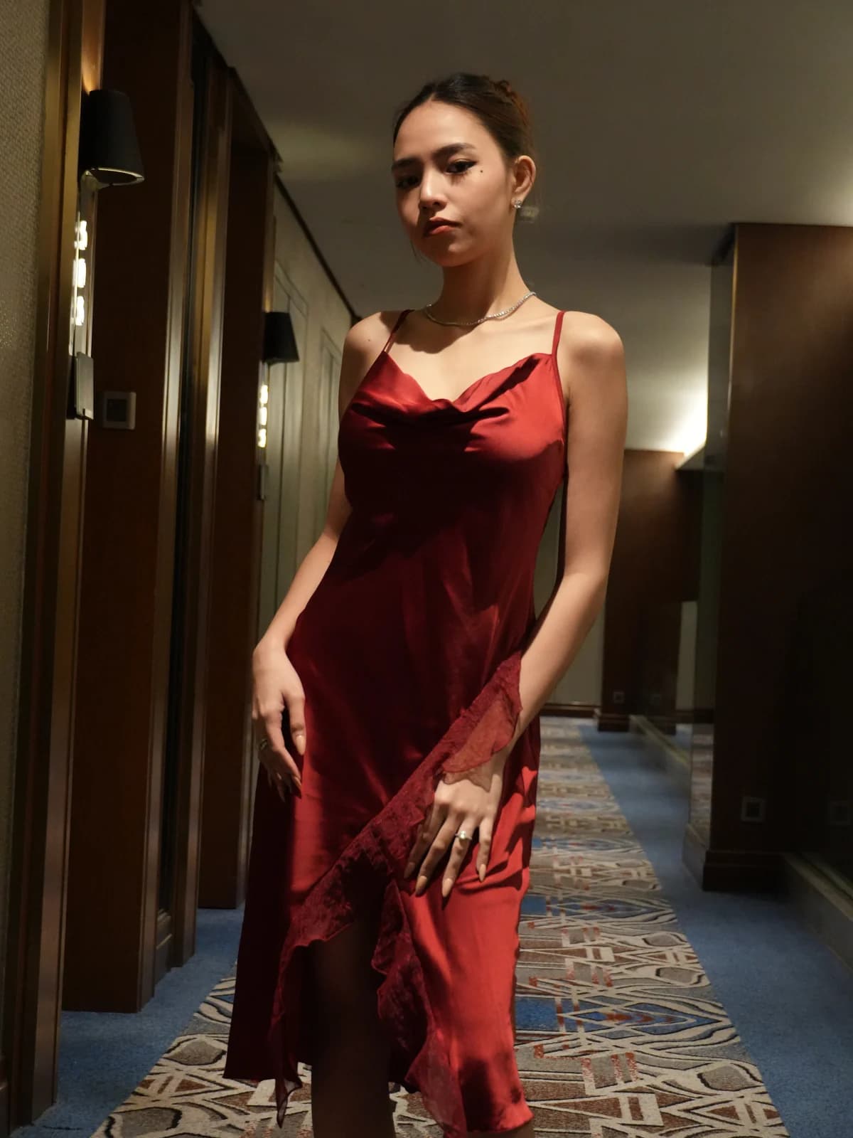 Merchant campaign preview: model in a burgundy satin chemise with a feathered red robe